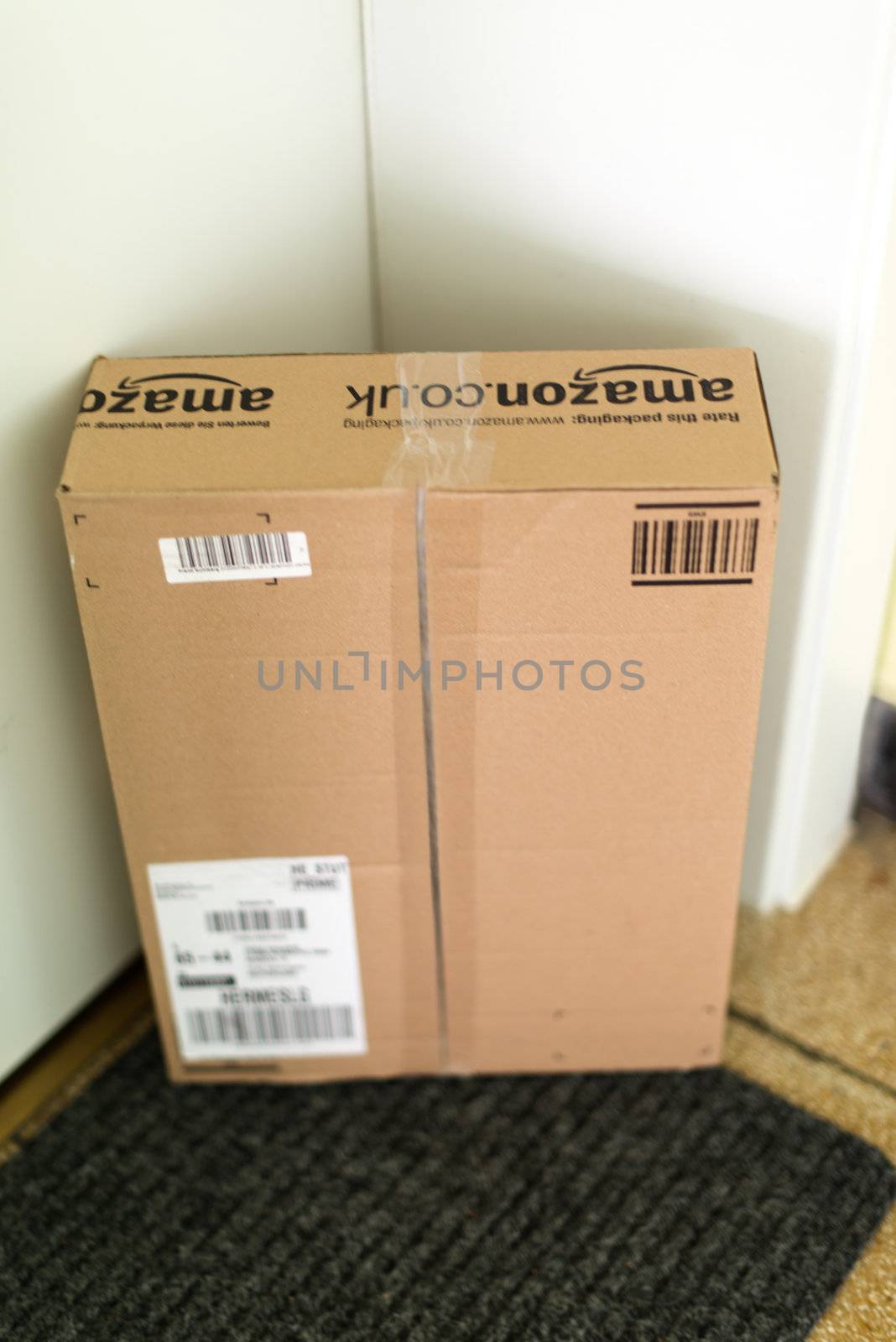 STUTTGART - SEPTEMBER 2: An Amazon.com parcel waiting at the front door of a flat on September 2, 2012 in Stuttgart, Germany. Amazon.com is delivering thousands of parcels every day to German households.