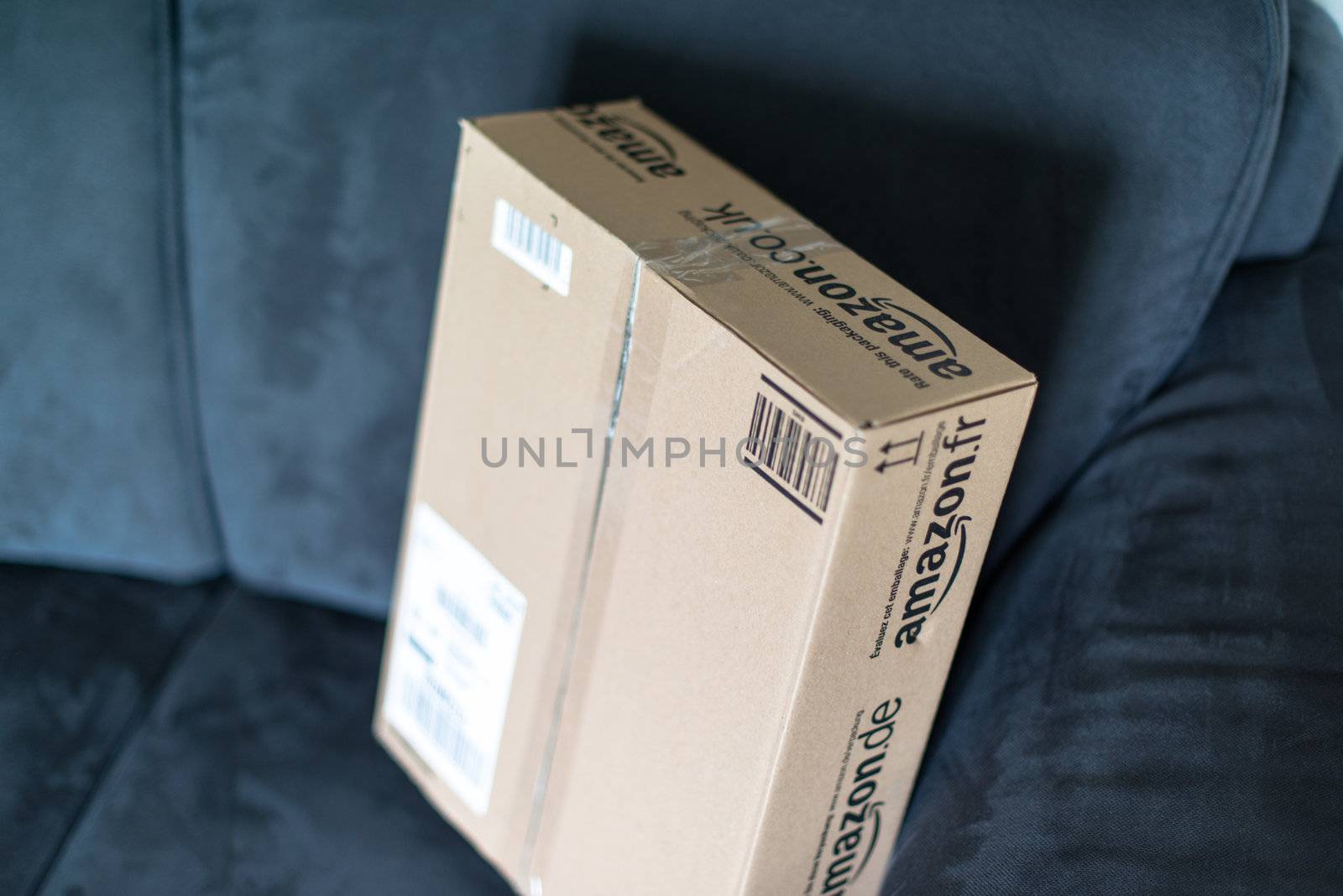 STUTTGART - SEPTEMBER 2: An Amazon.com parcel waiting on a sofa in a flat for being unpacked on September 2, 2012 in Stuttgart, Germany. Amazon.com is delivering thousands of parcels every day to German households.