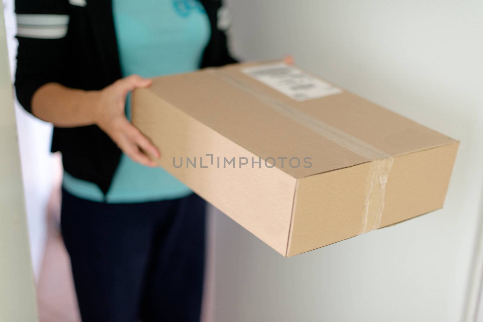 Woman picking up a parcel at her flat