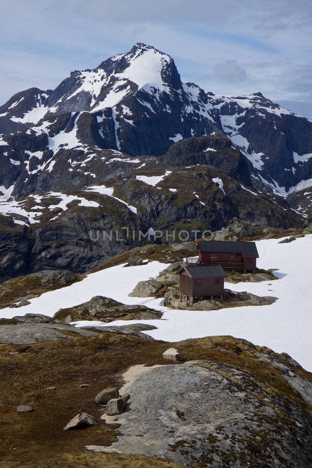 Hermannsdalstinden, highest peak of western Lofoten islands in Norway with mountain cabin in the foreground