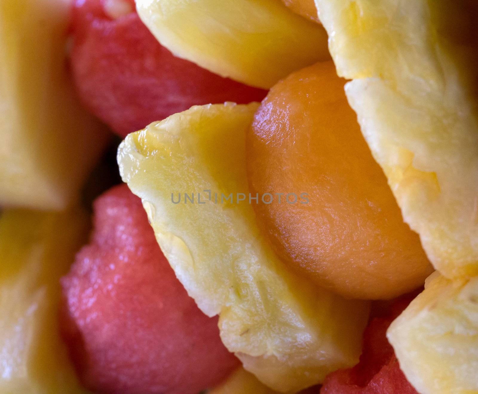 Close-up of sliced pineapple and melons.