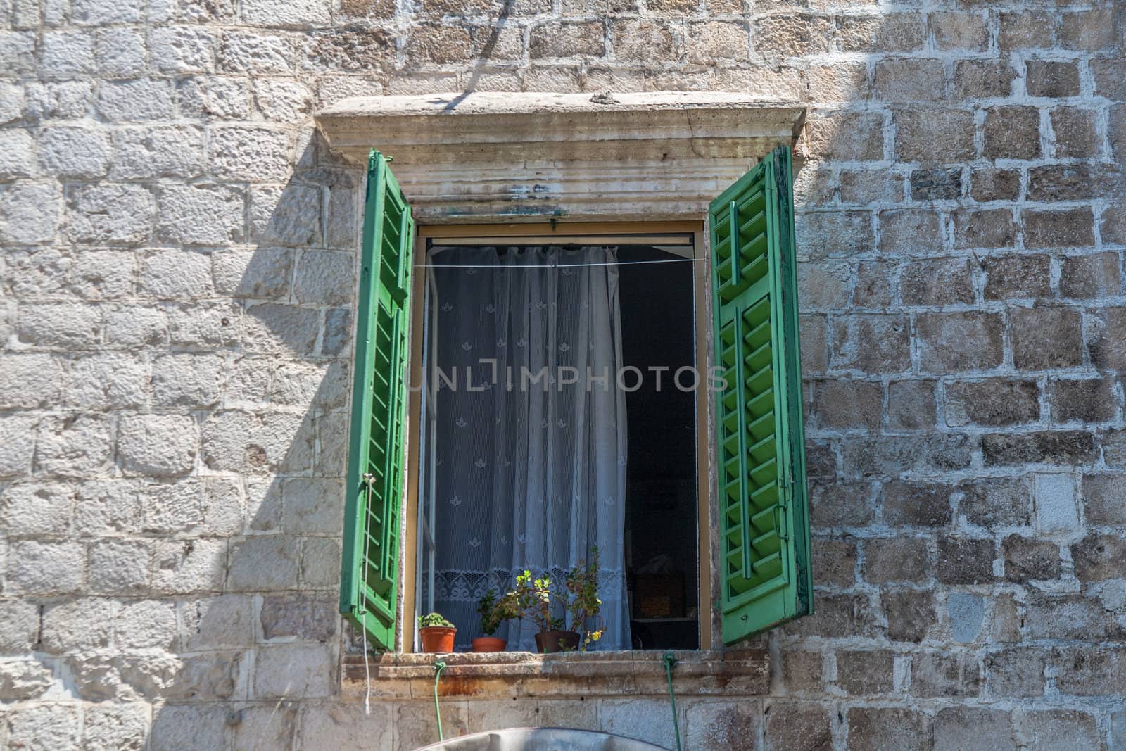 A window of a stony house in old town