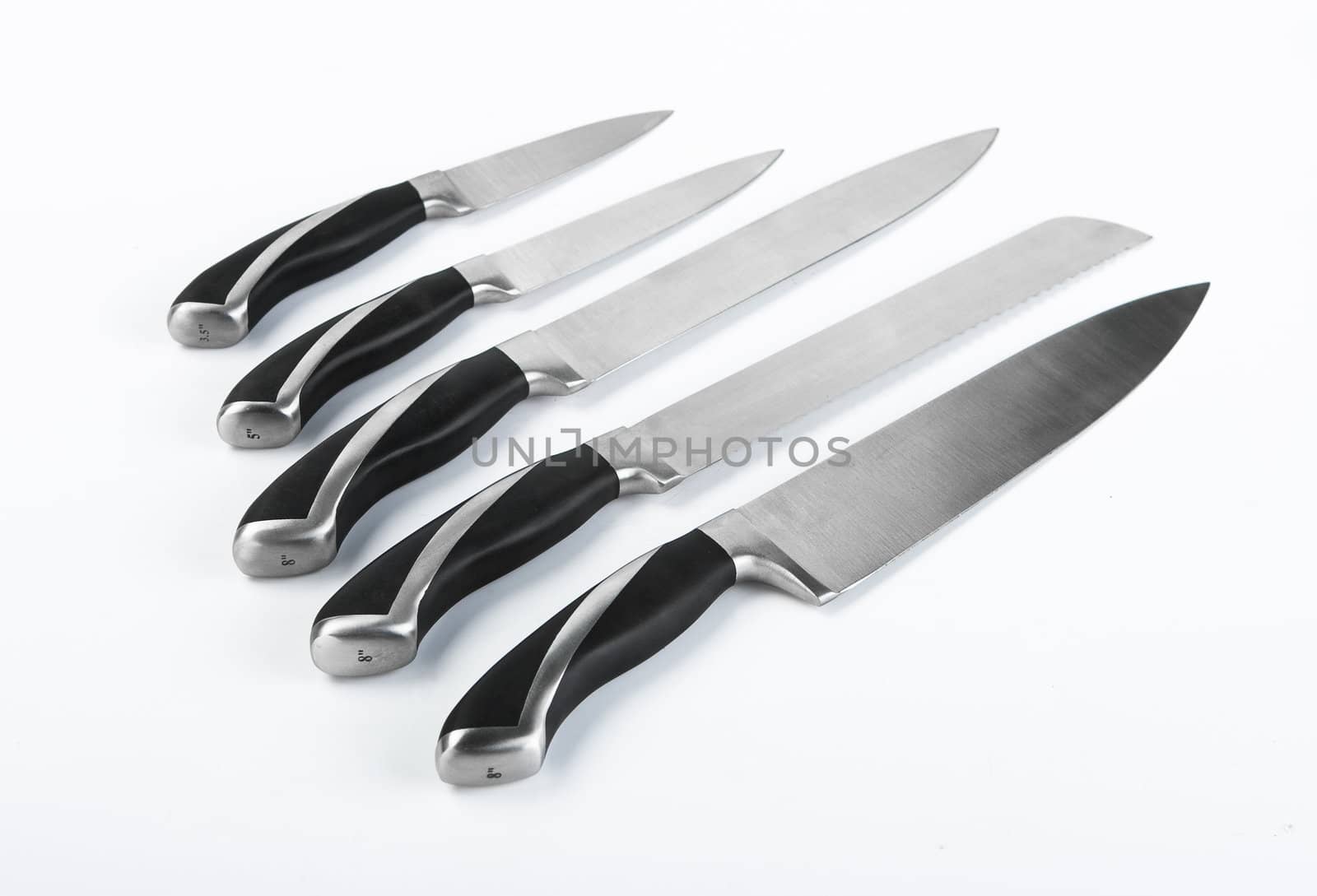 A set of professional chef's knives on a white background