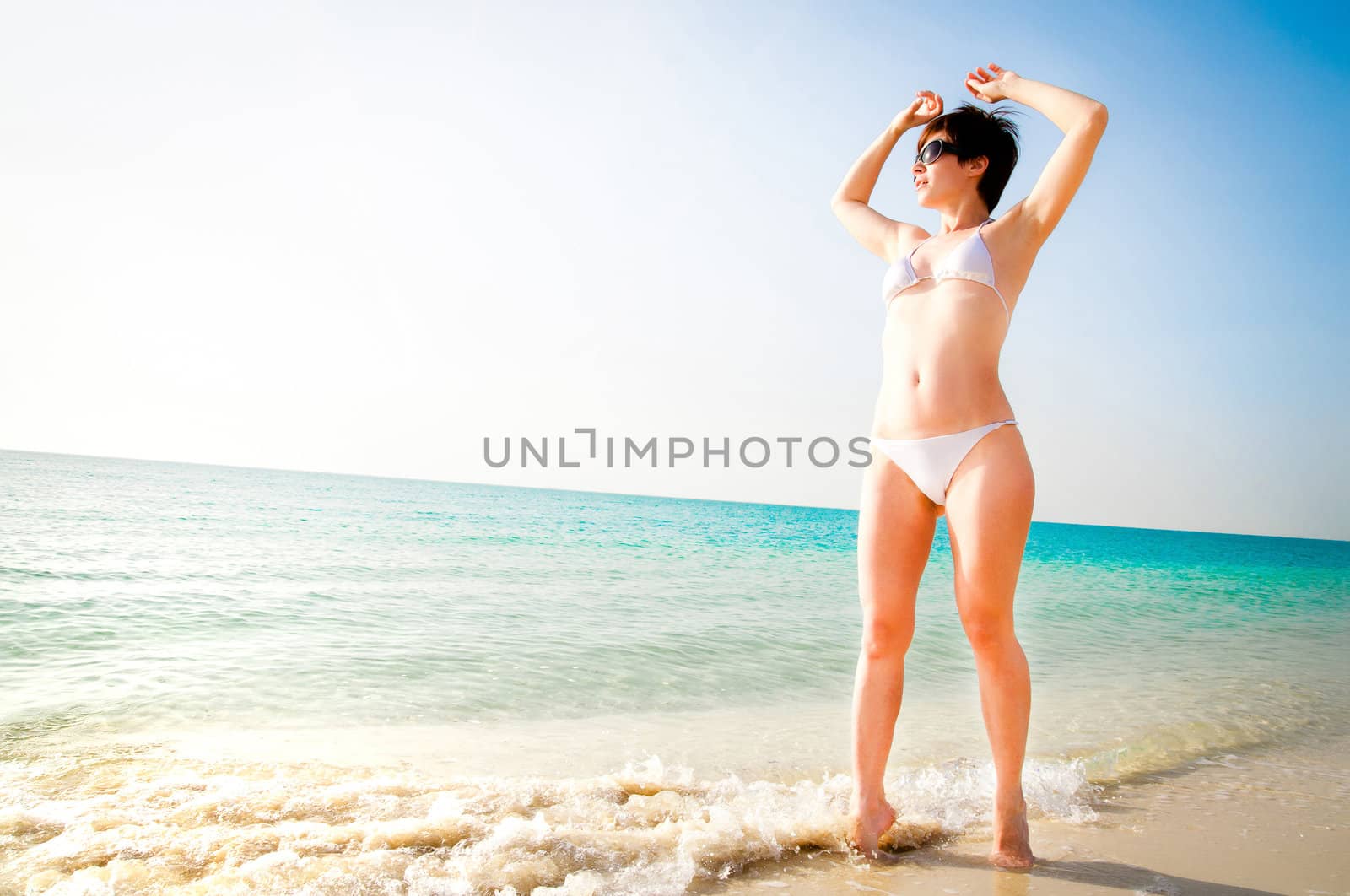 beautiful girl in a white bikini on the beach