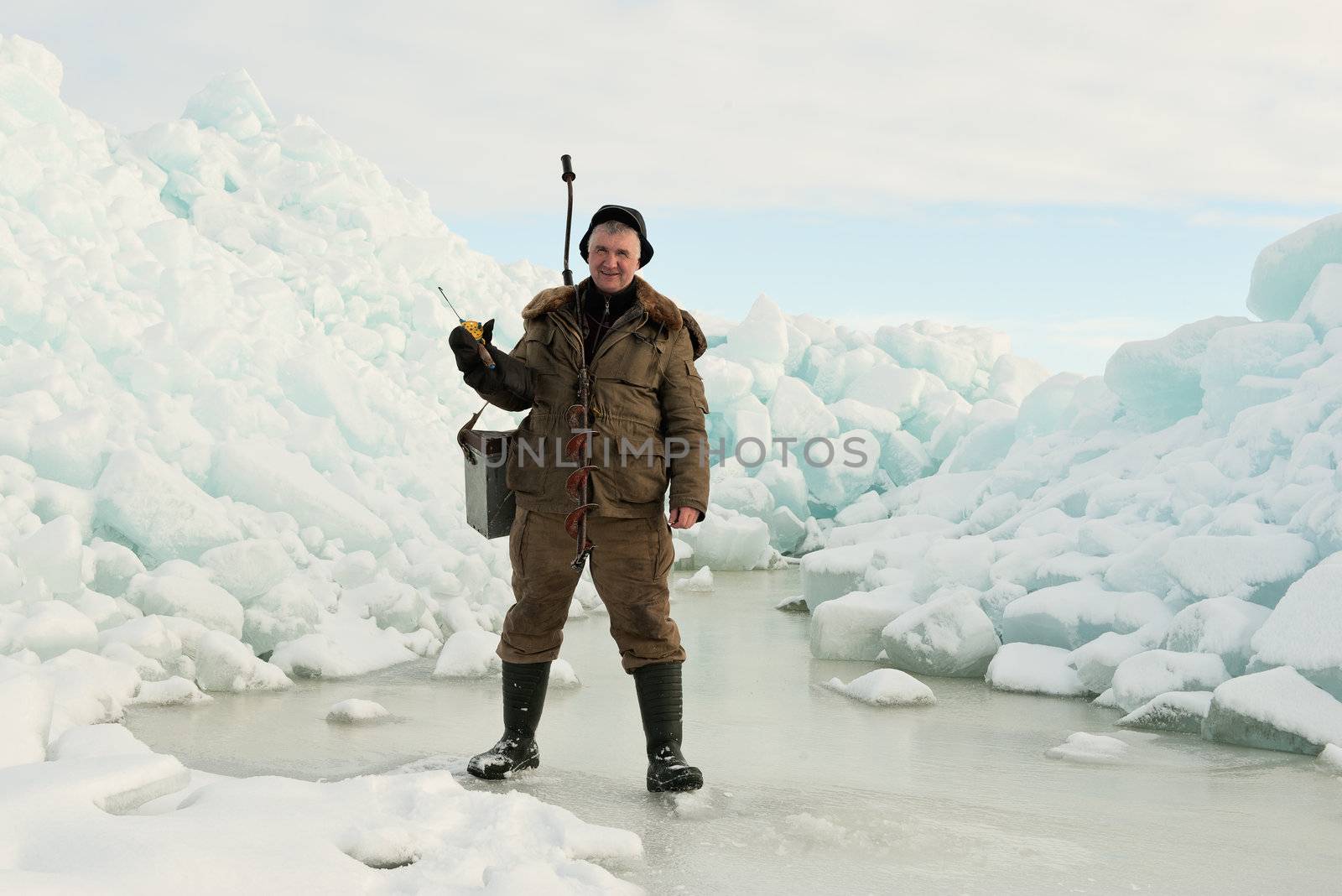 Ice Fishing. Fisherman with equipment for fishing on Ladoga Lake