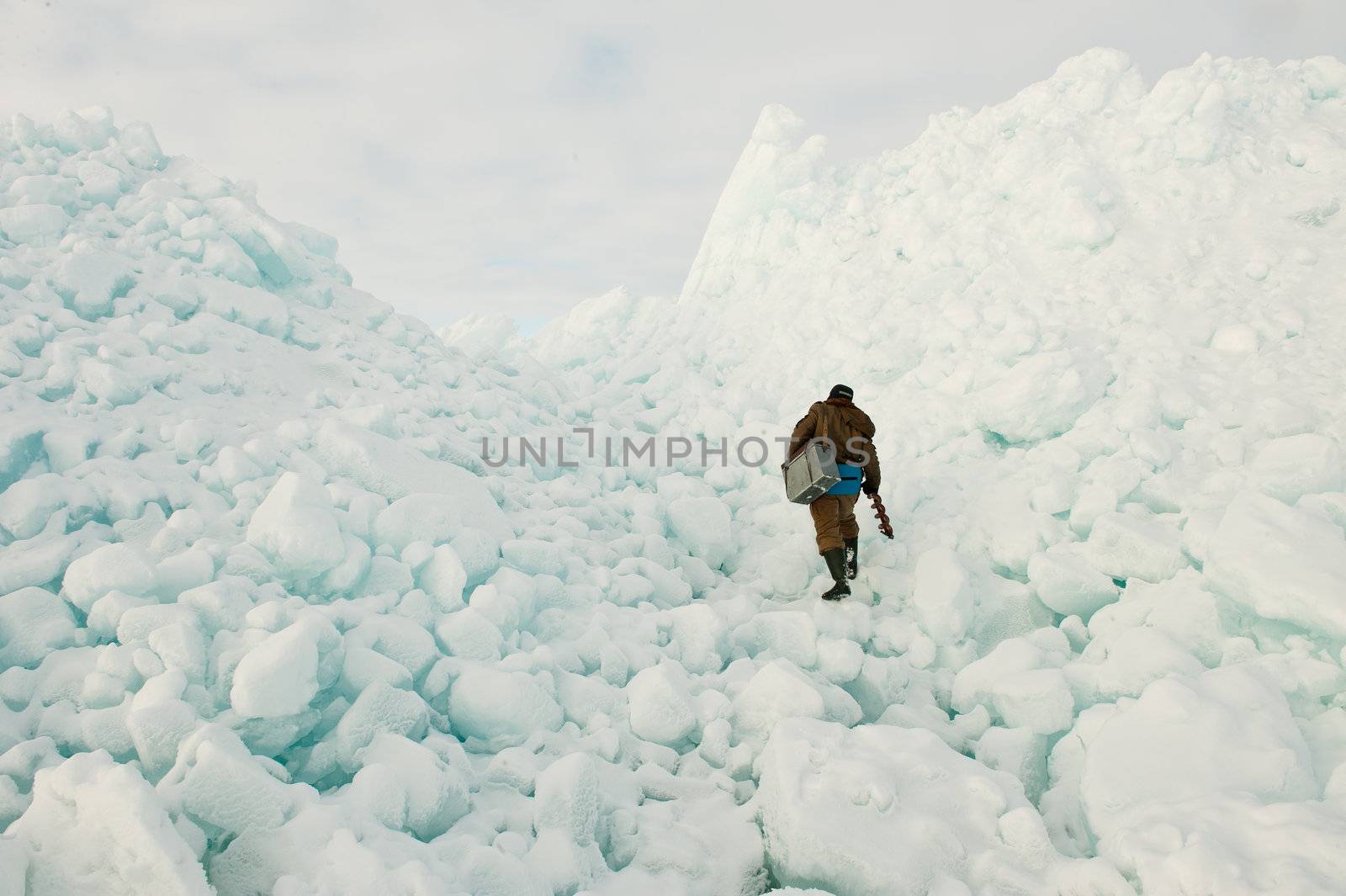  The fisherman clambering on ice blocks.