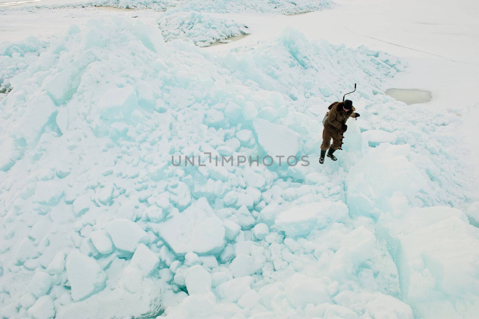  Winter fisherman on ice rock. by SURZ