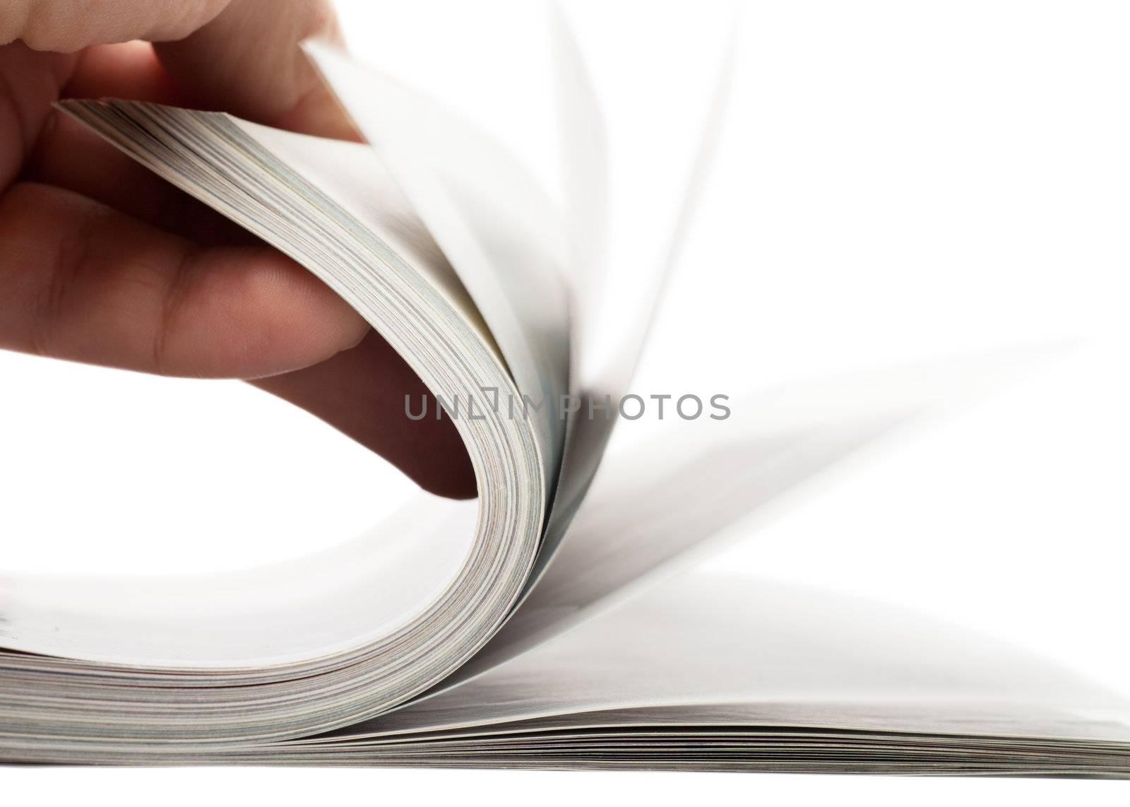 Turning over pages of thick magazine