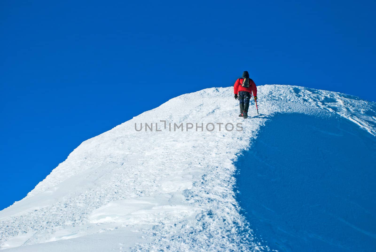 Lone male mountain climber  on the summit