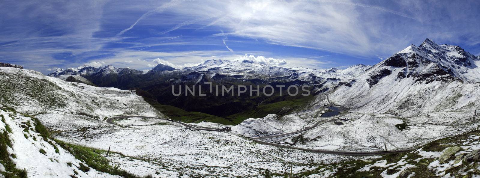 Wide panorama of alpine peaks in Austria covered by snow