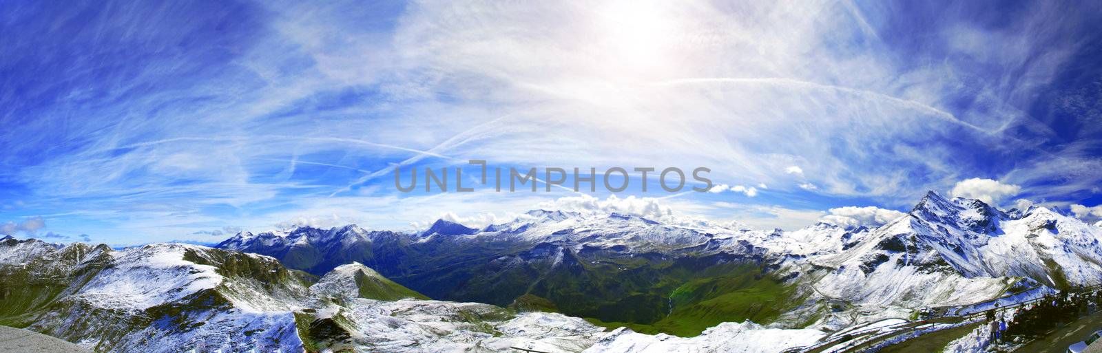 View at alpine mountain peaks - Grossglockner panorama- covered by snow and lost in clouds