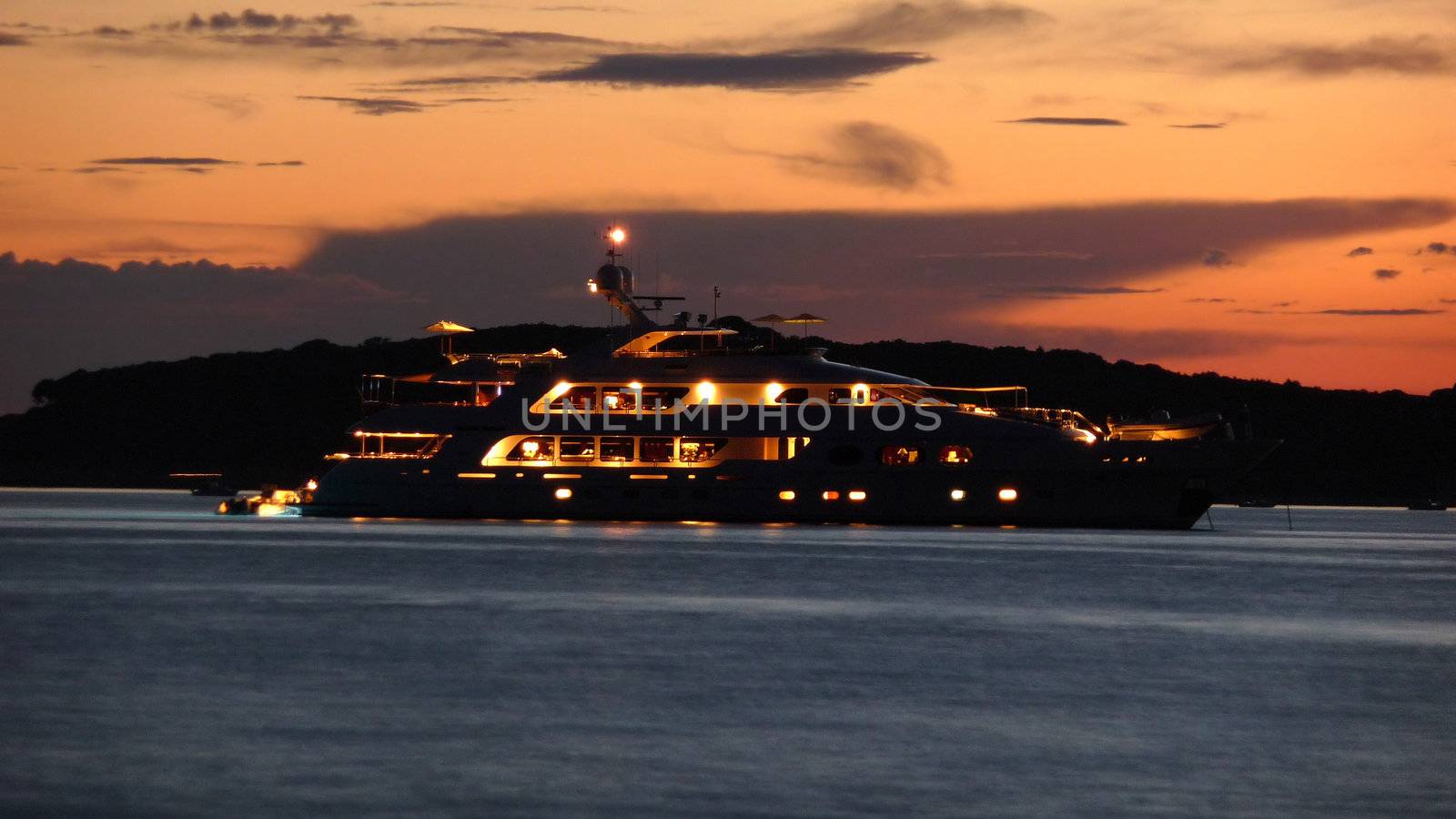 Illuminated luxury yacht at dusk on sea