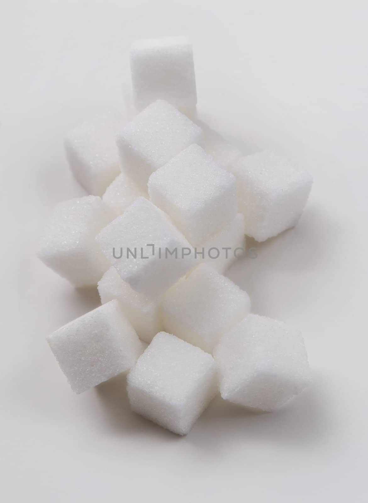 stack of white sugar cube against a white background