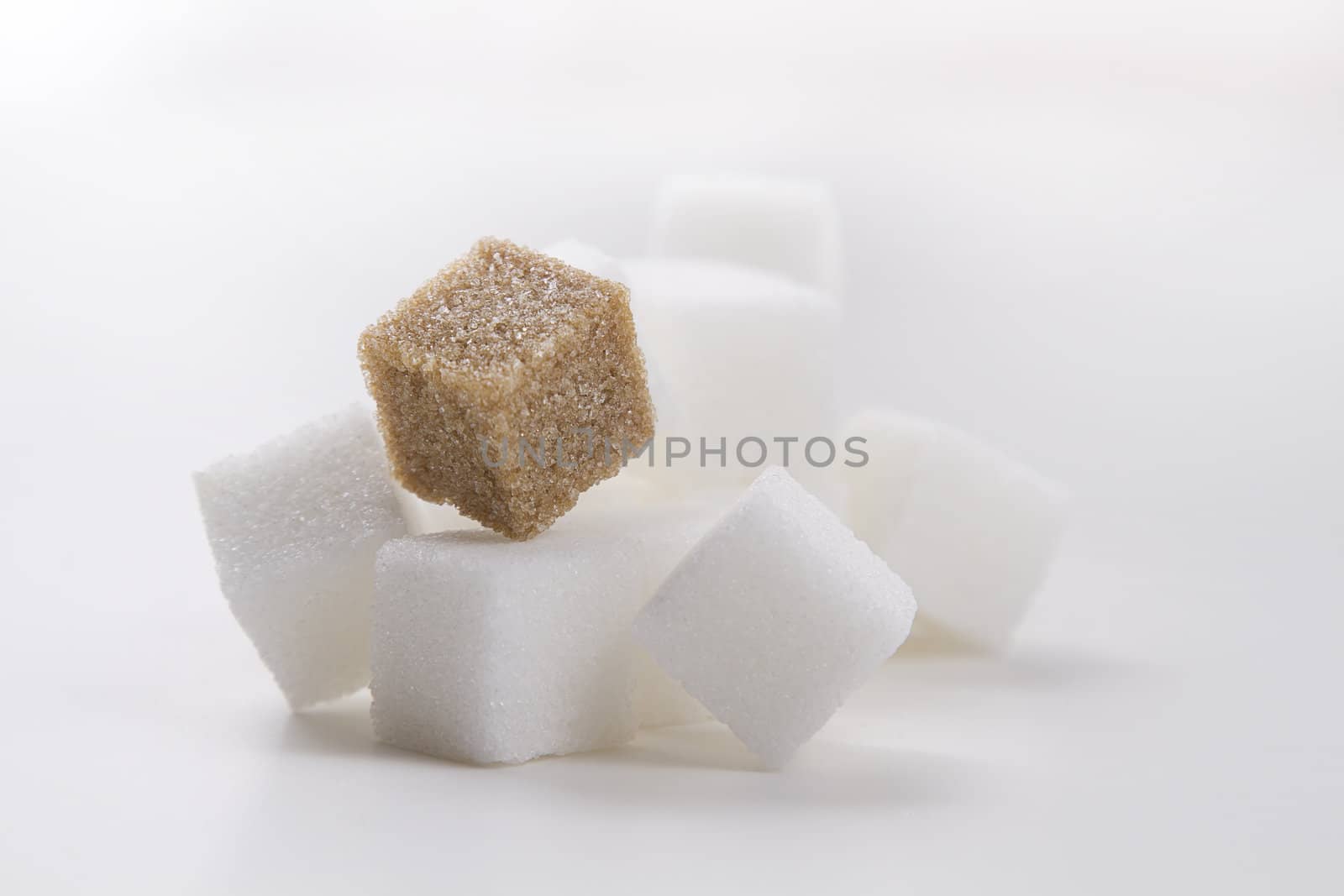 stack of white sugar cube with one brown sugar cube