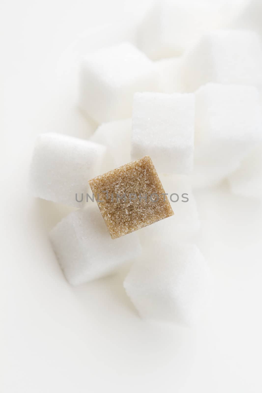 stack of white sugar cube with one brown sugar cube