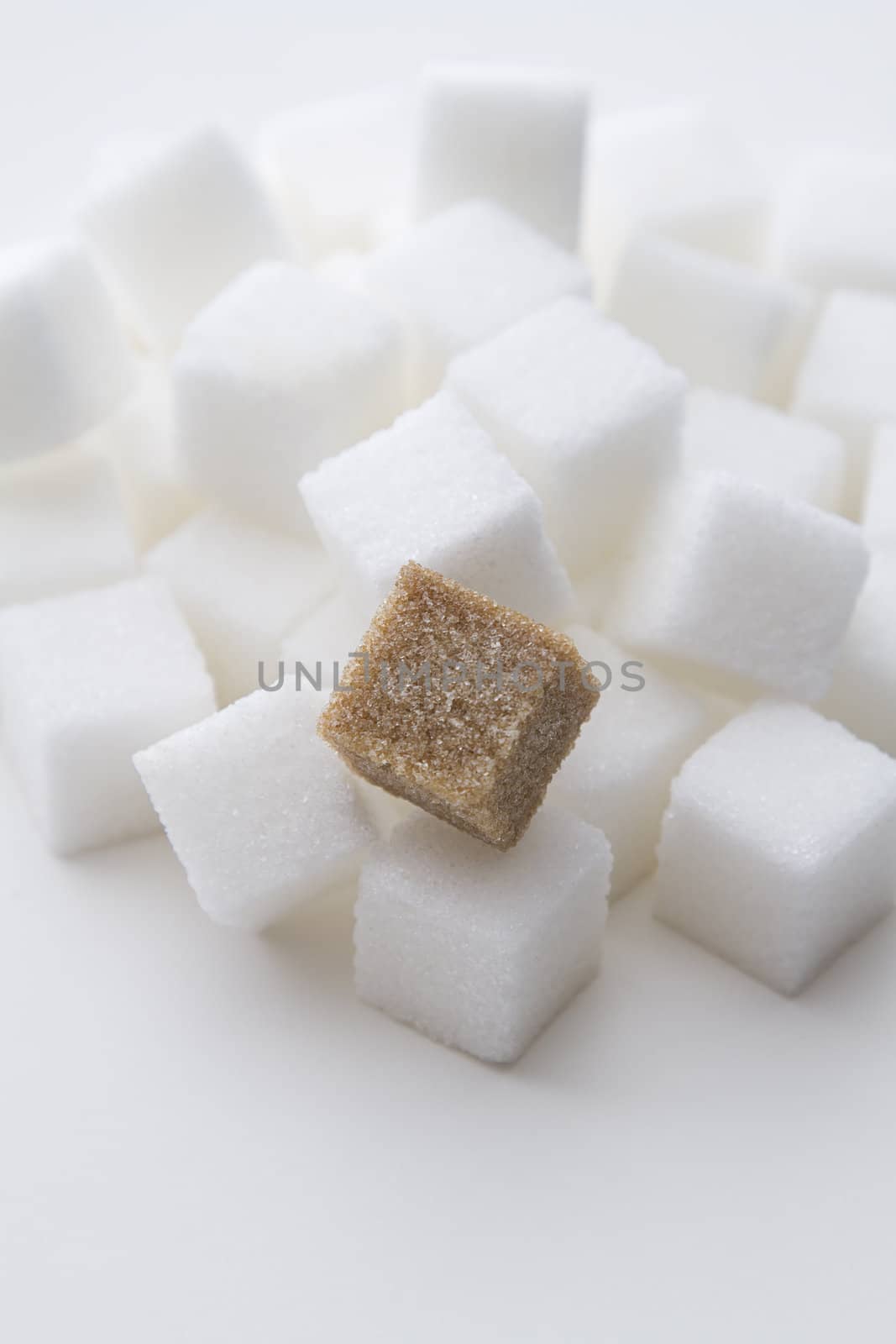 stack of white sugar cube with one brown sugar cube