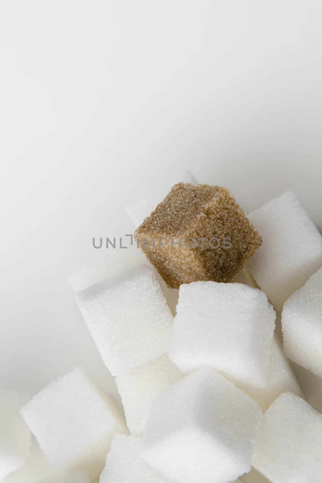 stack of white sugar cube with one brown sugar cube