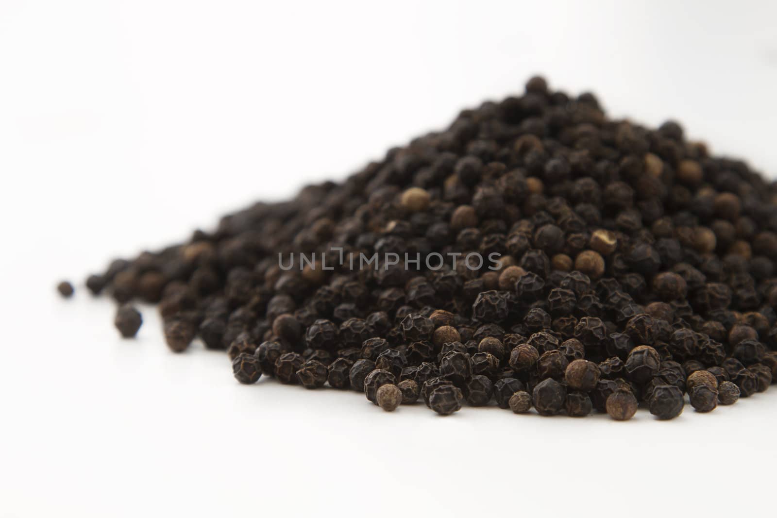close up view of a mountain of black pepper