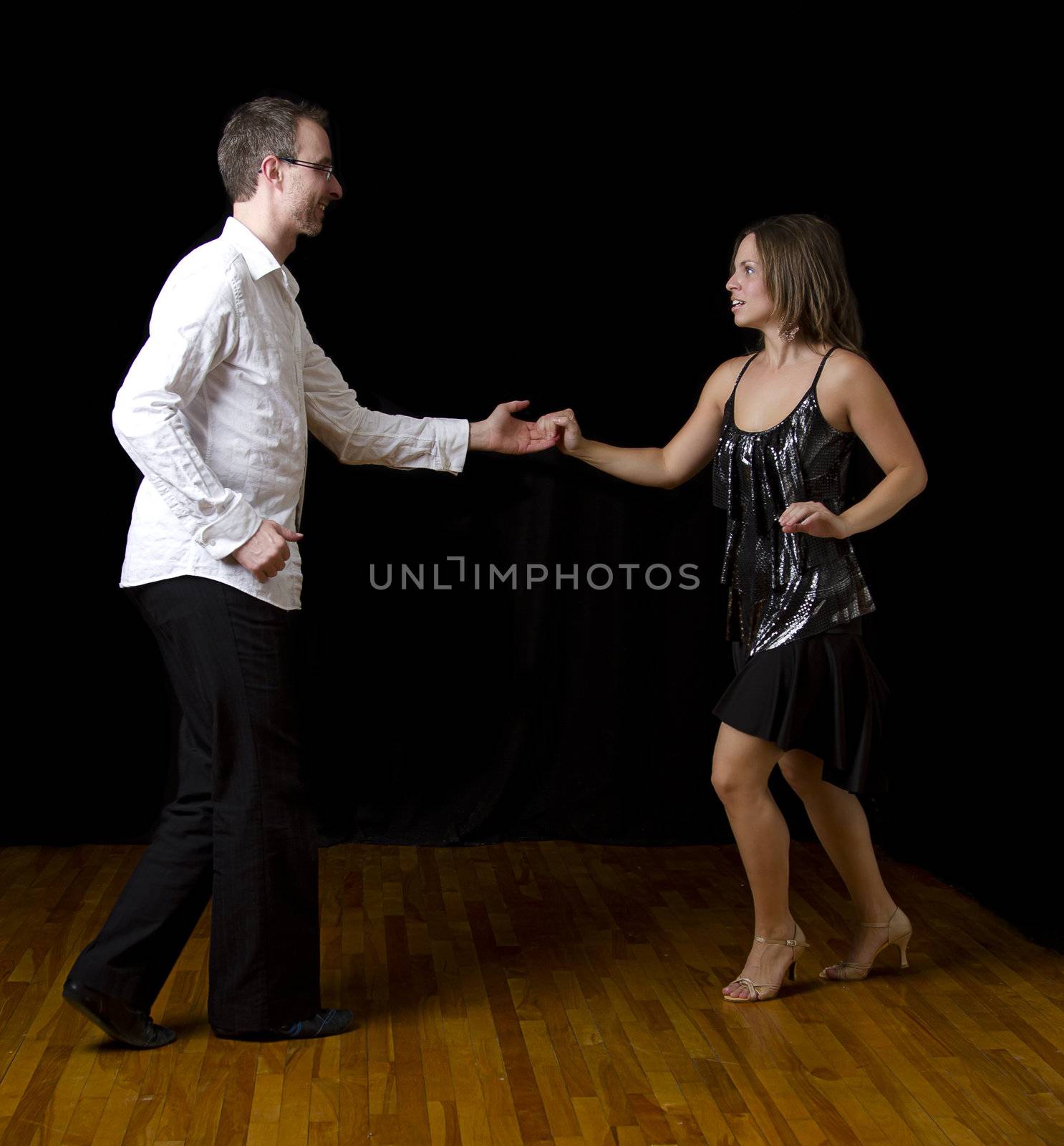 couple dancing salsa in the middle of a pose