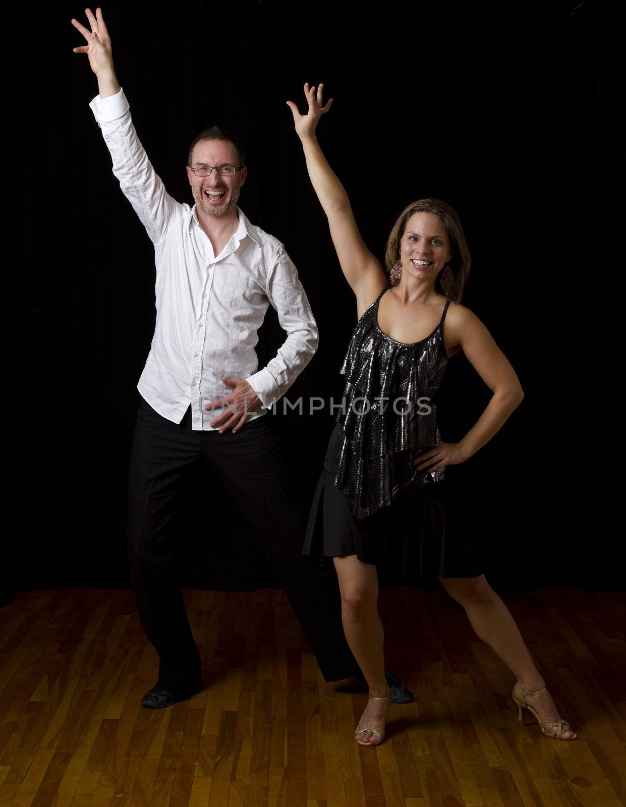 couple dancing salsa in the middle of a pose