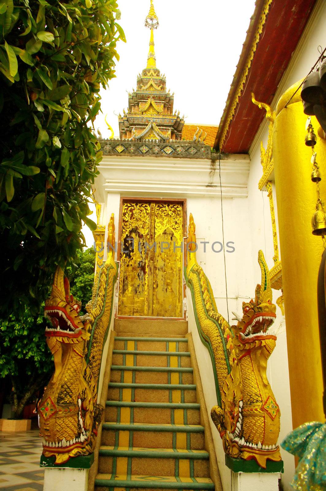 Back door of the temple Wat Phrathat Doi Suthep in Chiang Mai in the north-western Thailand.
As usual the stairs are often decorated with dragons mythical animals in the Buddhist religion.