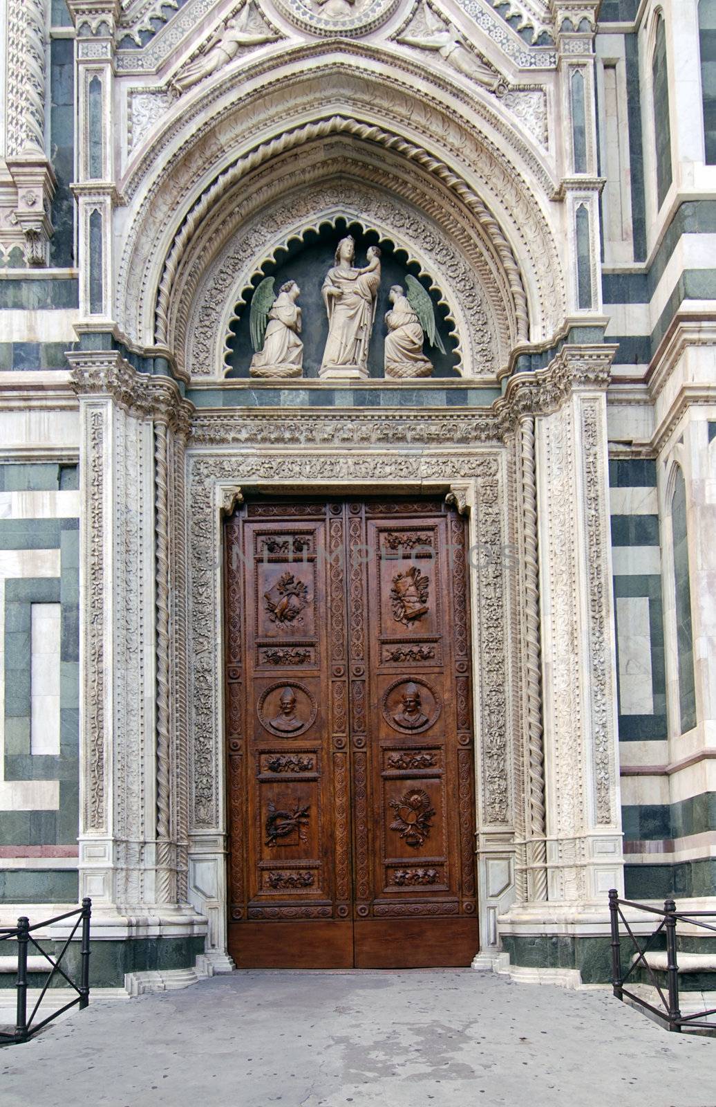 Beautiful renaissance wooden door of the cathedral Santa Maria del Fiore in Florence, Italy