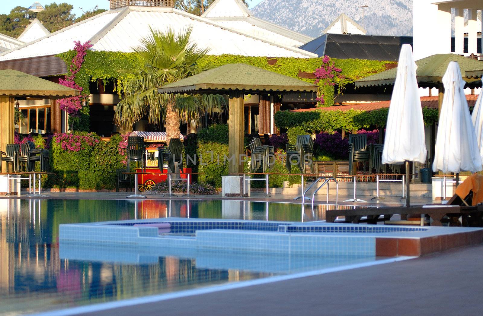 beautiful swimming pool with parasols and view to mountain