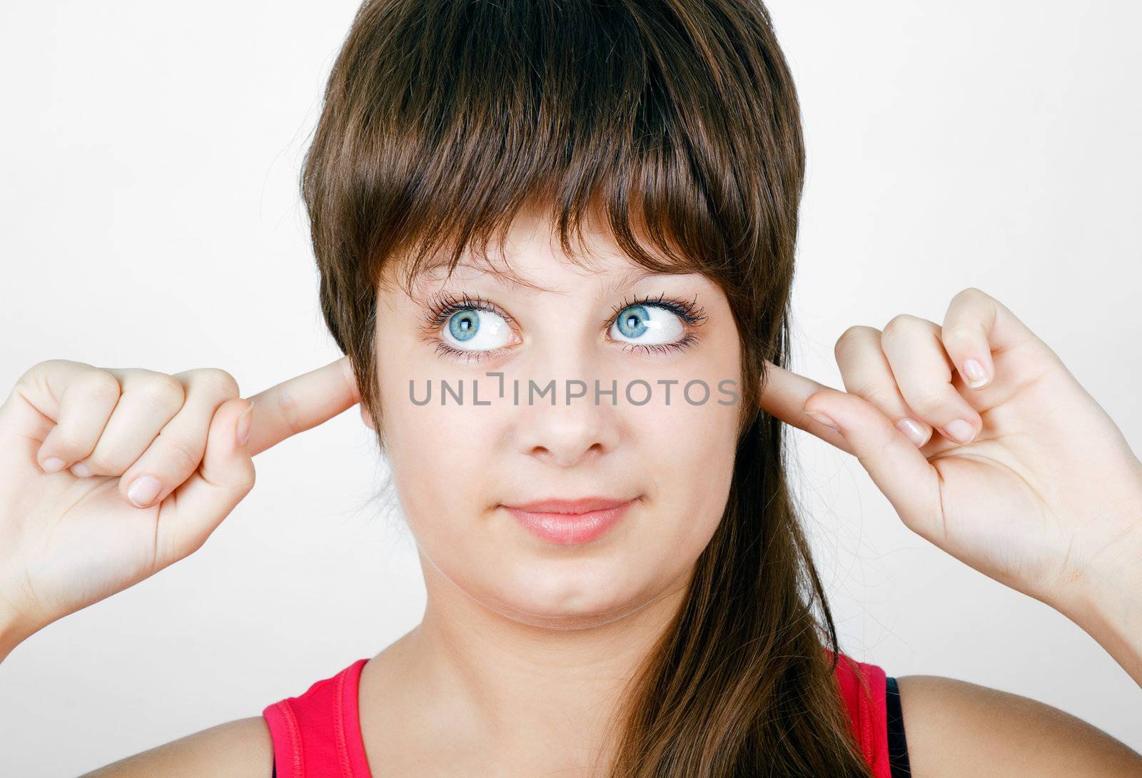 blue-eyed girl plugs fingers in his ears