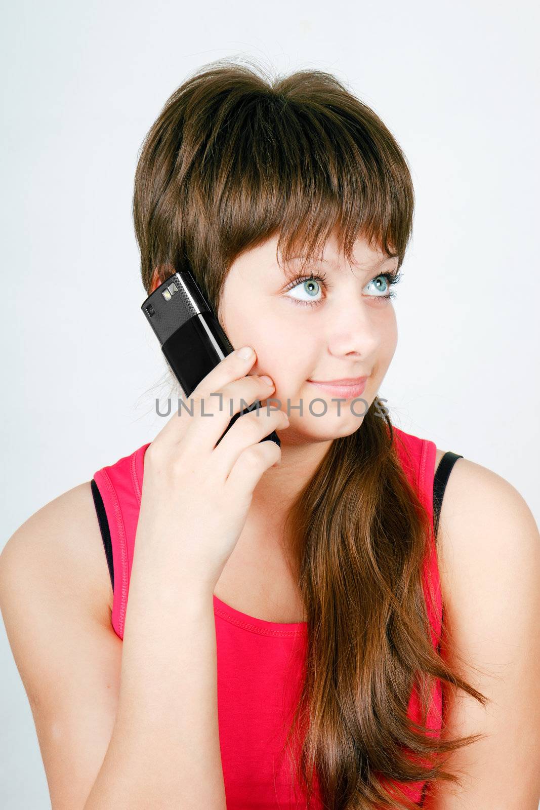 blue-eyed teen girl talking on a cell phone