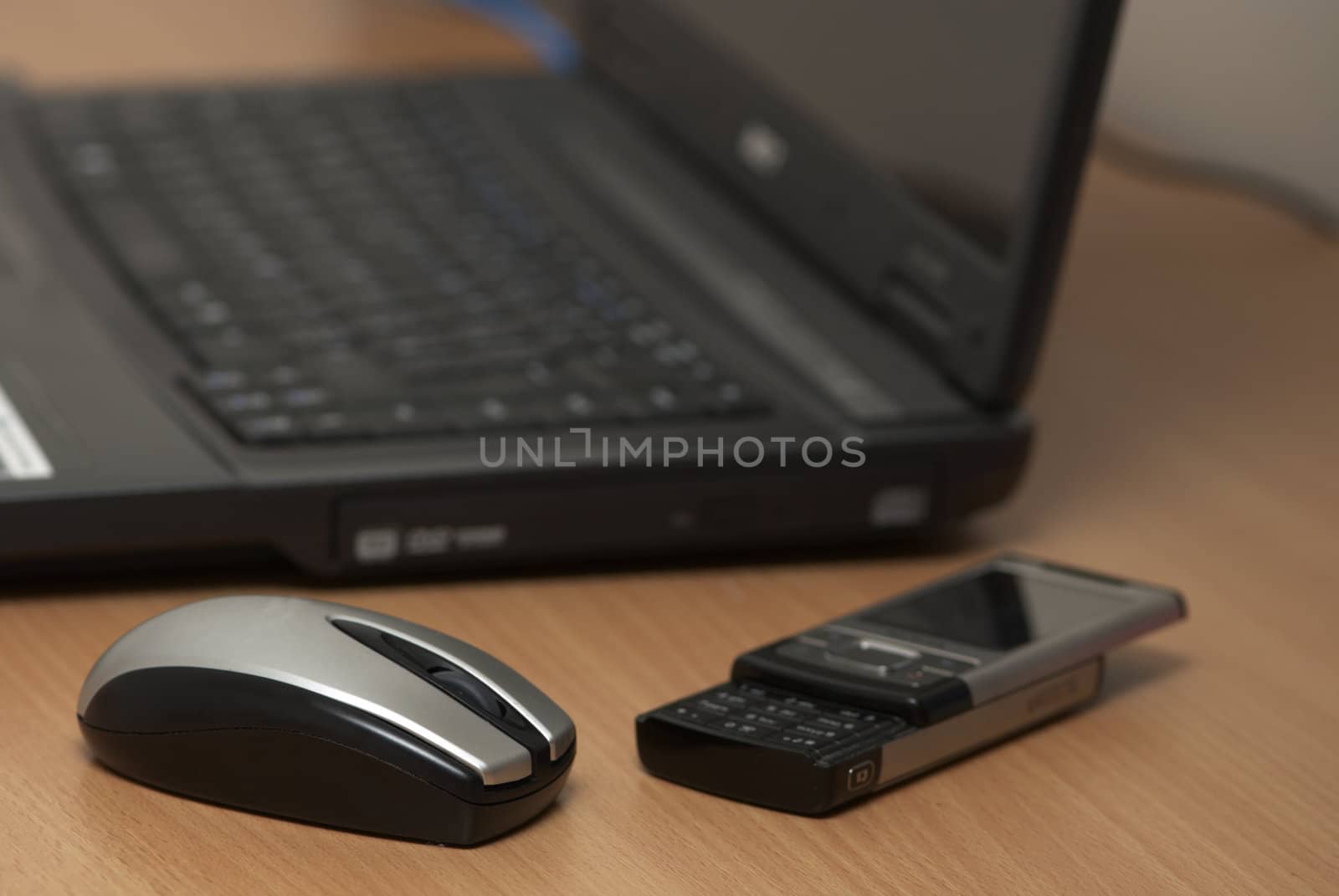 A notebook, mouse and telephone on a table