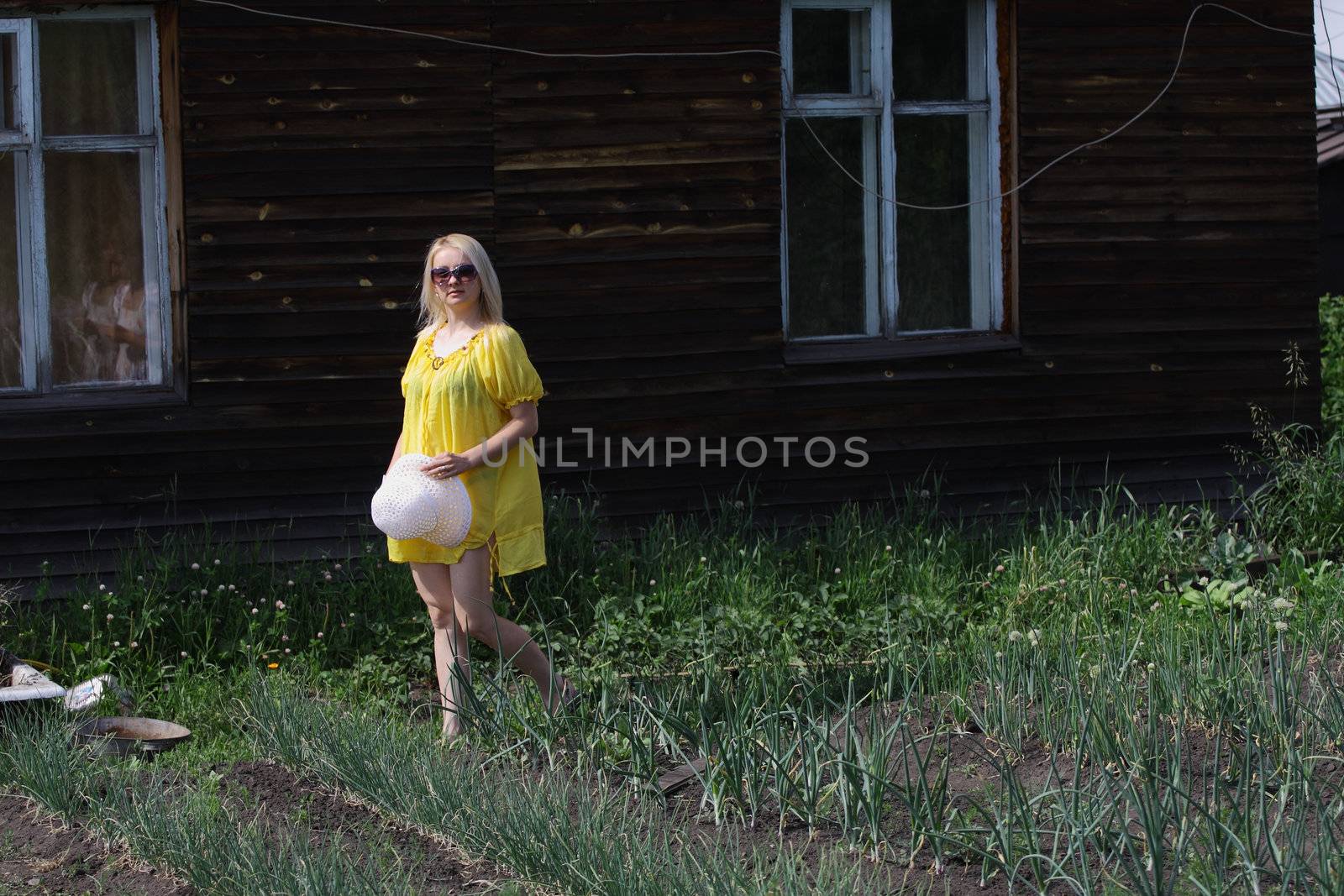 Smiling woman wearing sunglasses in the countryside