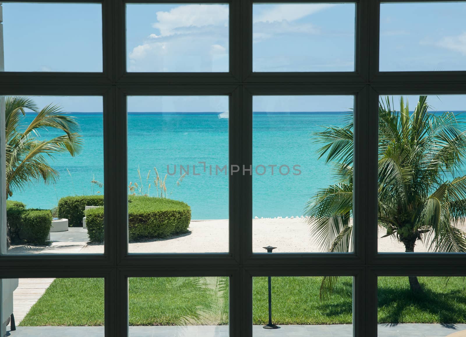 Caribbean view through grid of window frame.