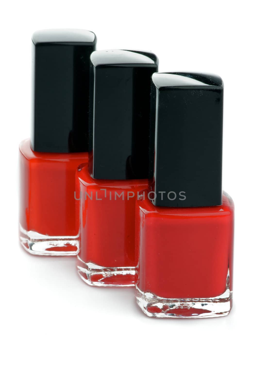 Three Shades of Red Bright Nail Varnishs isolated on white background