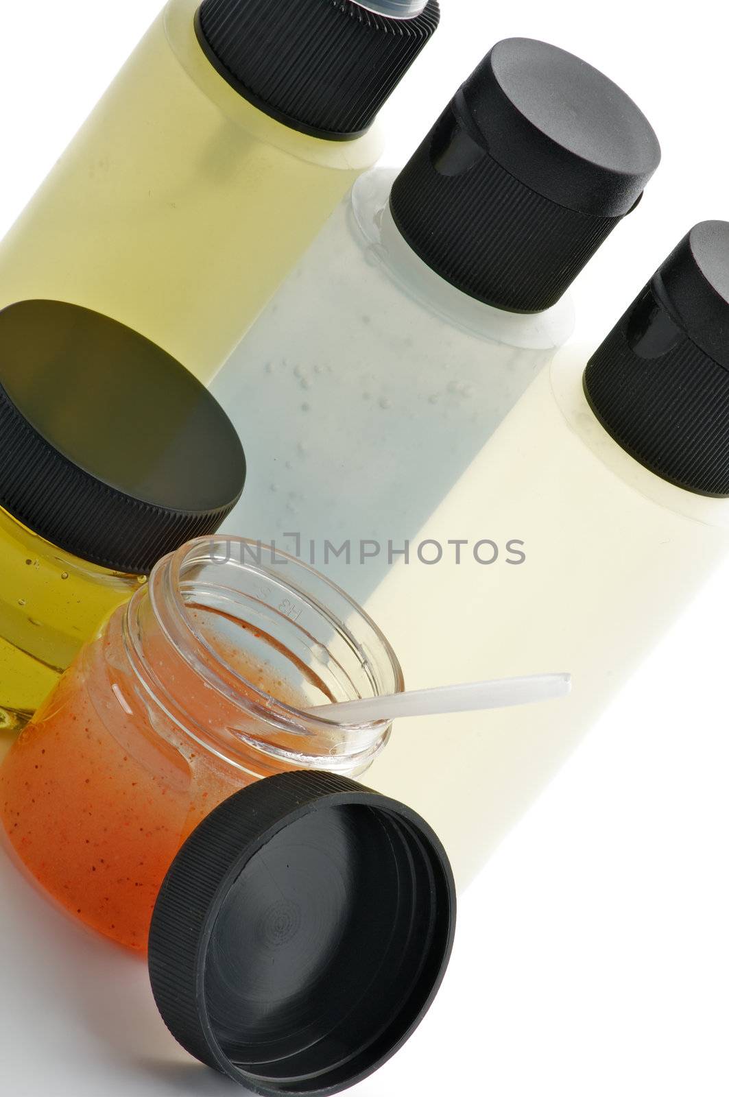 Facial Cosmetics with Apricot Scrub, Facial Cleanser, Foam, Toner and Moisturizer in Containers isolated on white background