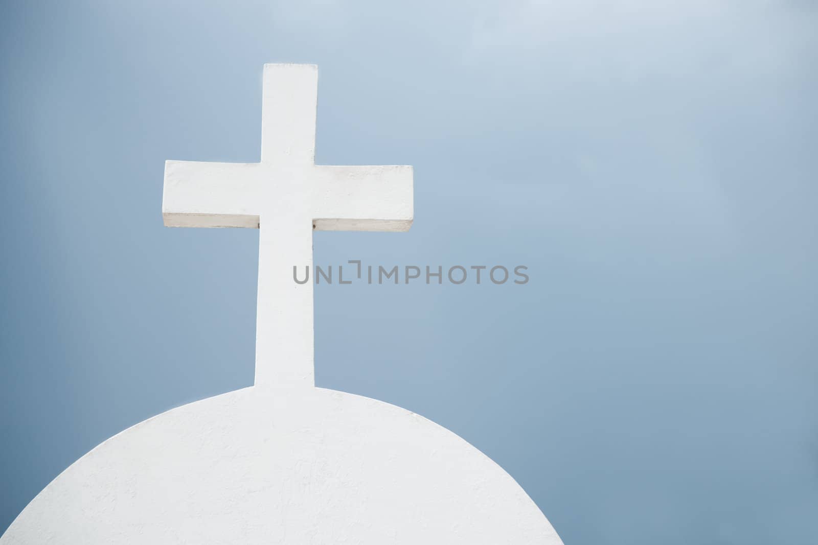 White concrete cross on headstone.