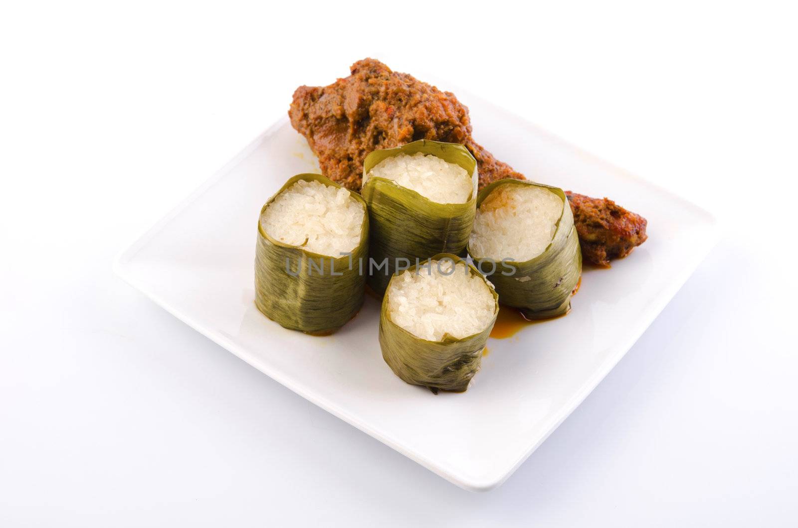 Traditional malay cuisine of  glutinous rice lemak lemang and rendang ayam