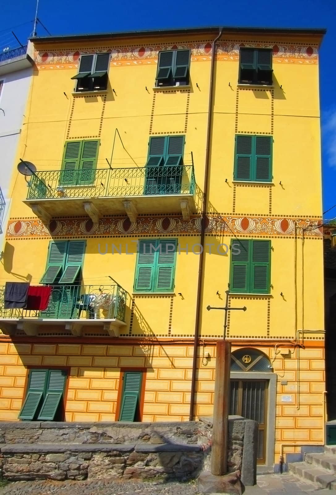 Yellow house in village on Italian coast                               