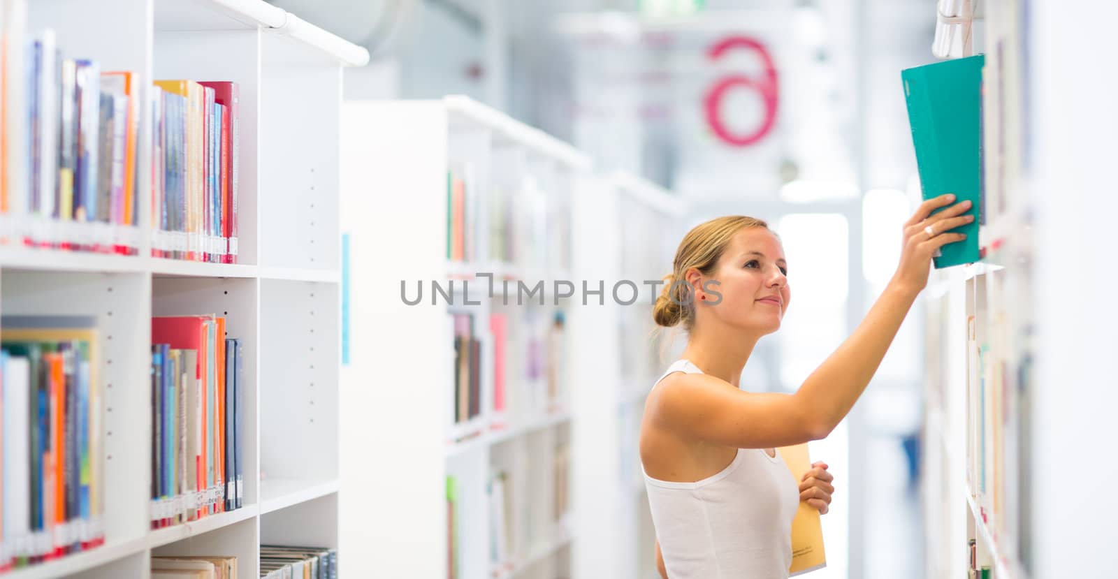 pretty young college student in a library (shallow DOF; color toned image)