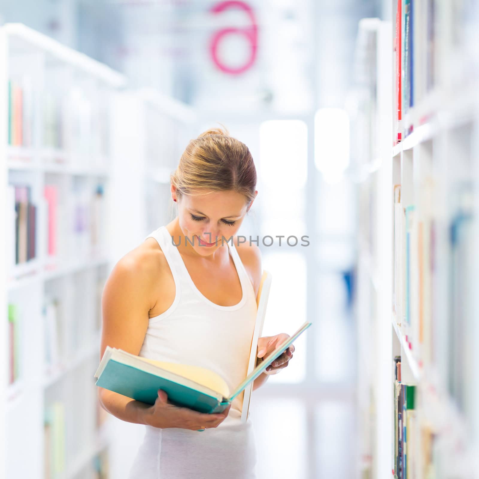 Pretty young college student in a library (shallow DOF; color toned image)