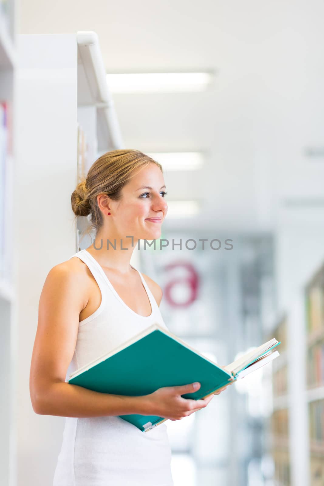 Pretty young college student in a library (shallow DOF; color toned image)