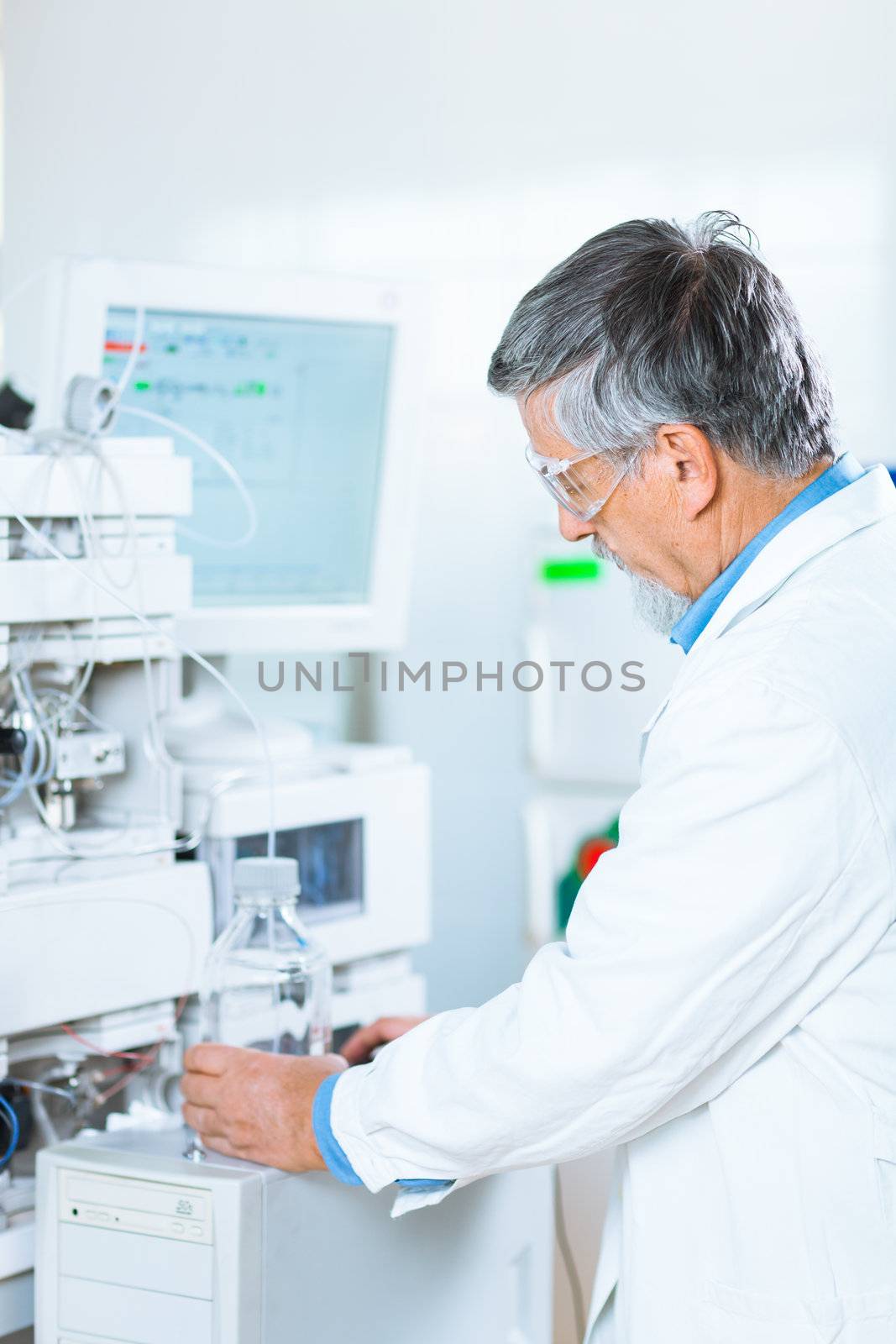 Senior male researcher carrying out scientific research in a lab (shallow DOF; color toned image)