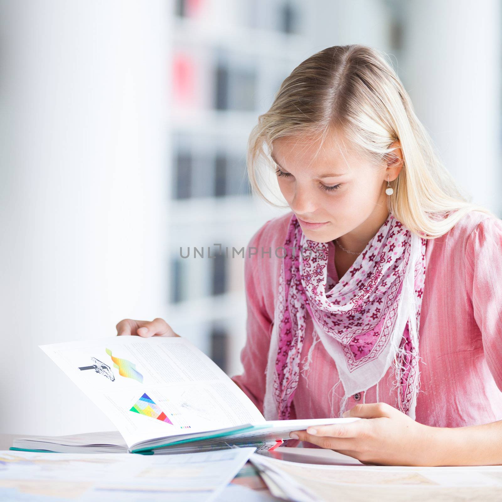 in the library - pretty female student with books working in a high school library (color toned image)