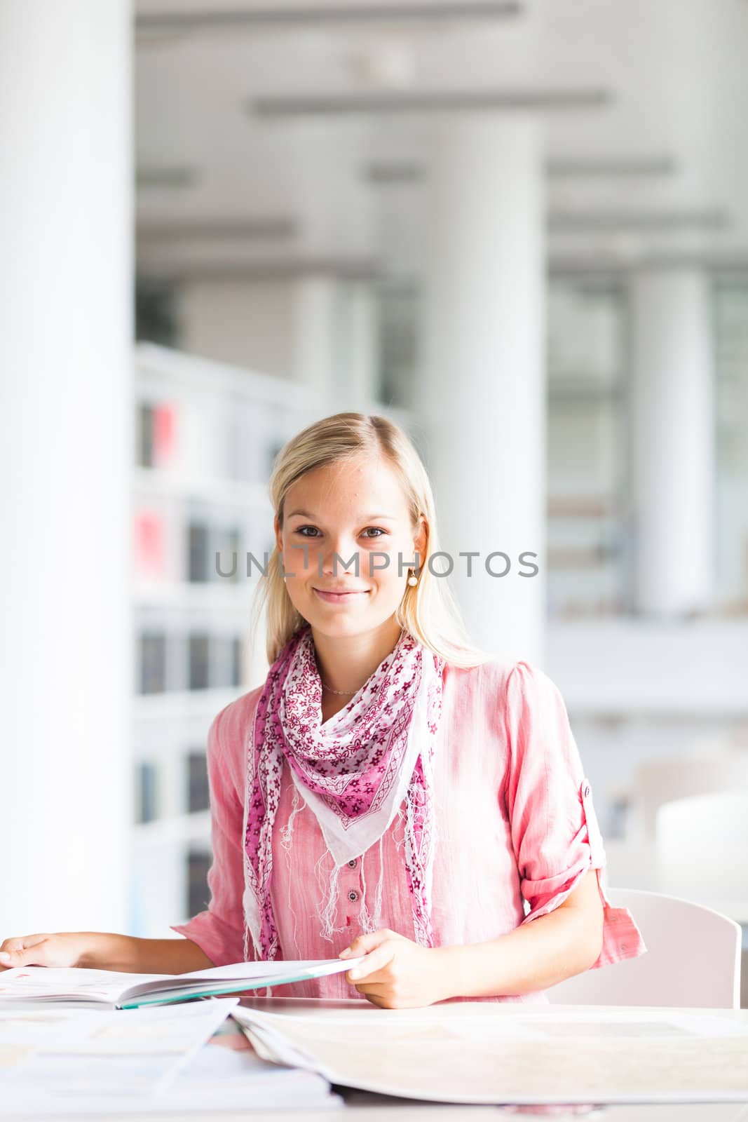 in the library - pretty female student with books working in a high school library (color toned image)