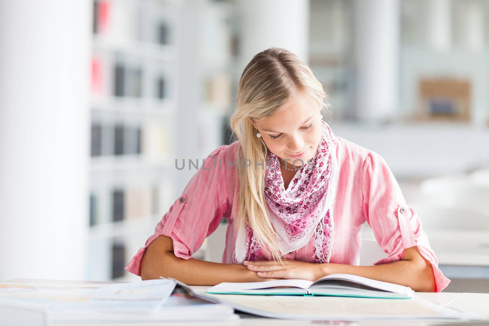 in the library - pretty female student with books working in a high school library (color toned image)