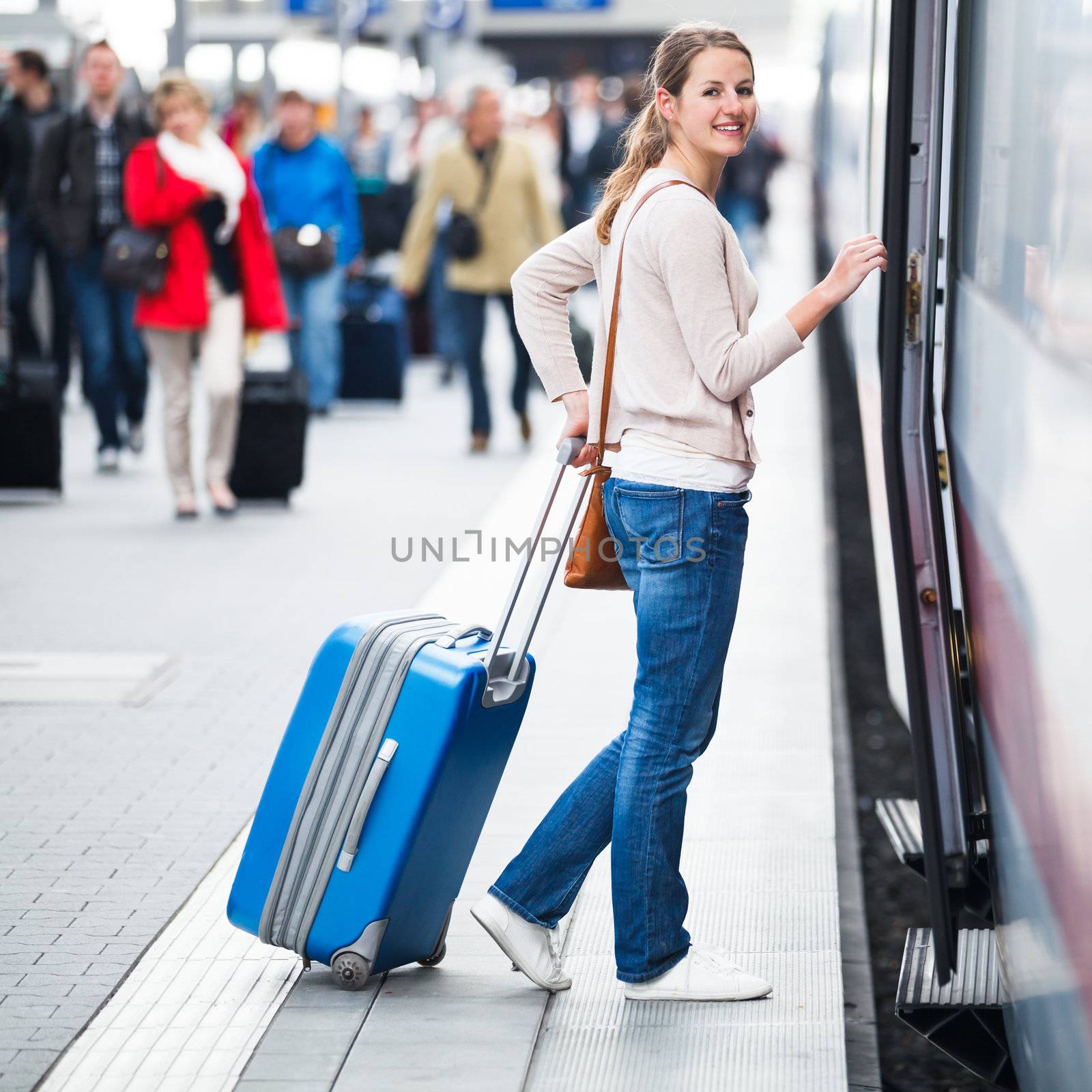 Pretty young woman boarding a train by viktor_cap