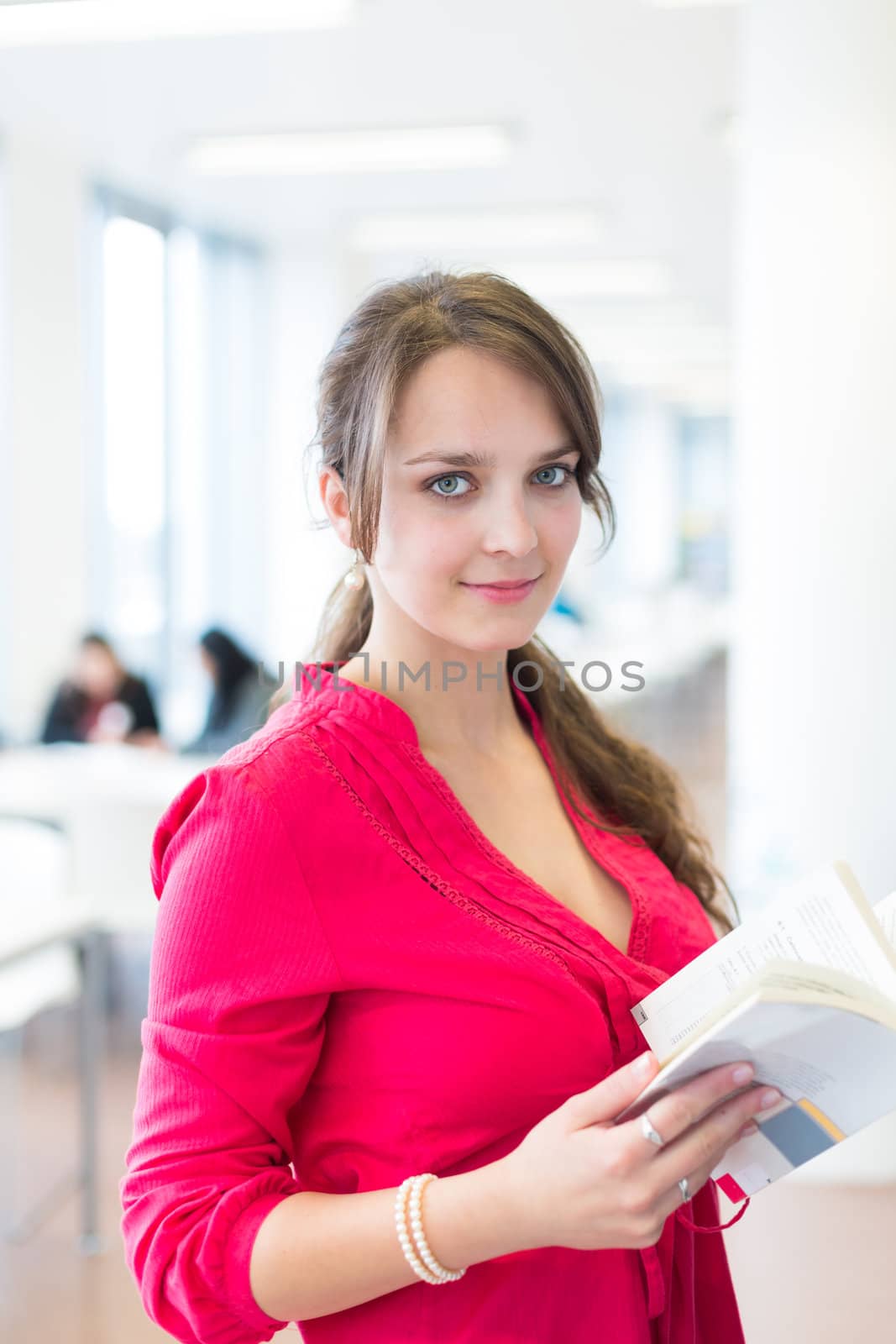 Pretty young college student in a library (shallow DOF; color toned image)