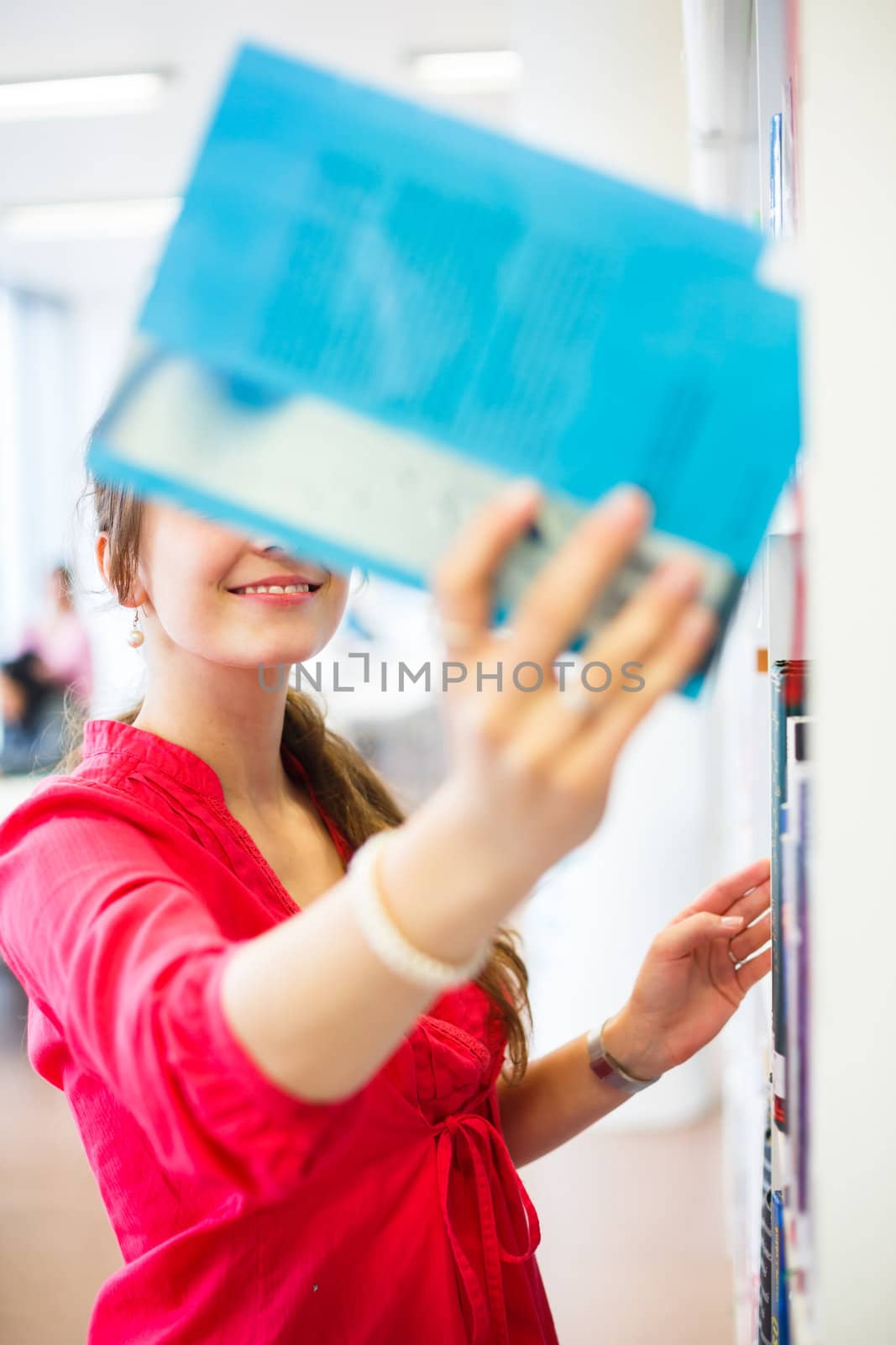 Pretty young college student in a library (shallow DOF; color toned image)