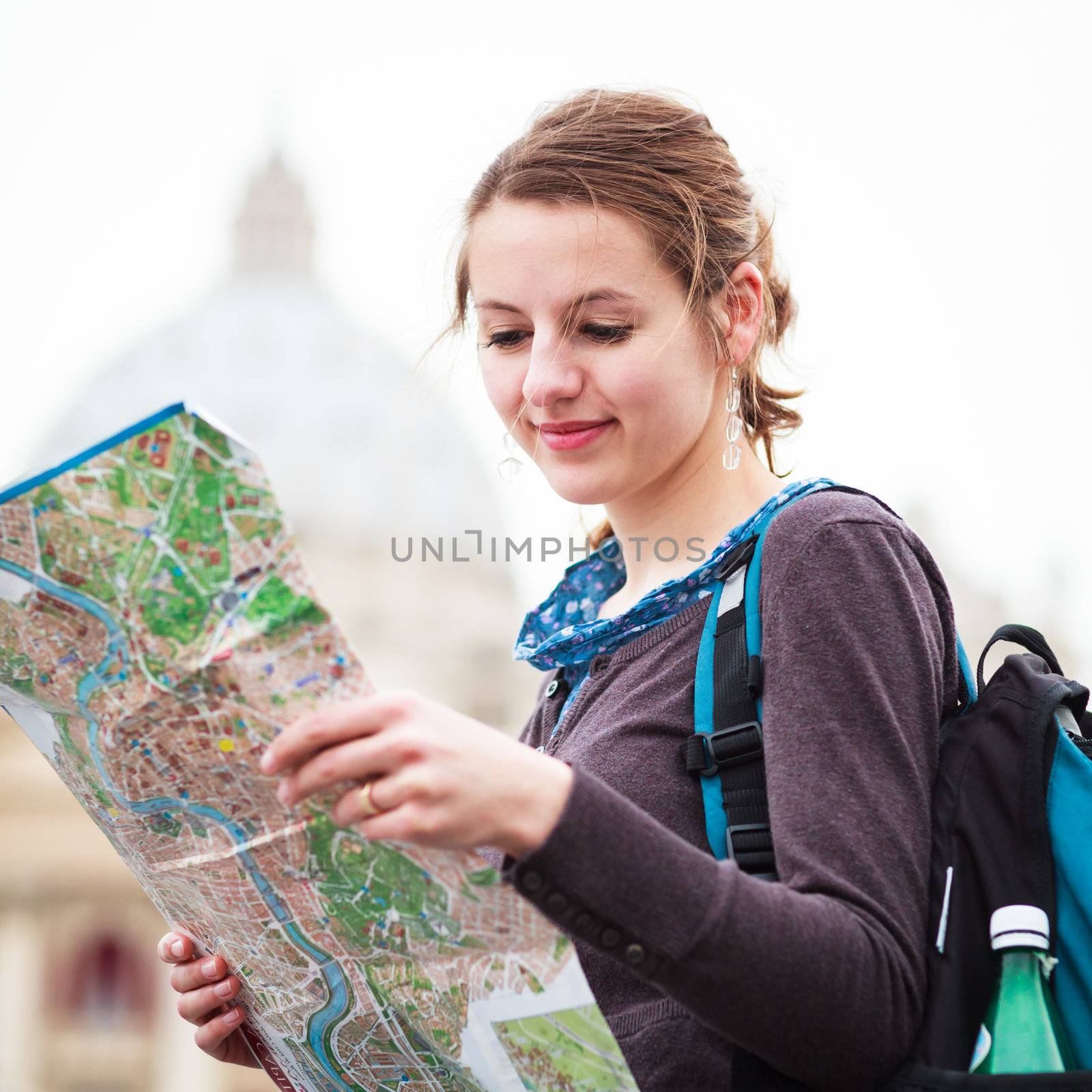 Pretty young female tourist studying a map at St. Peter's square by viktor_cap