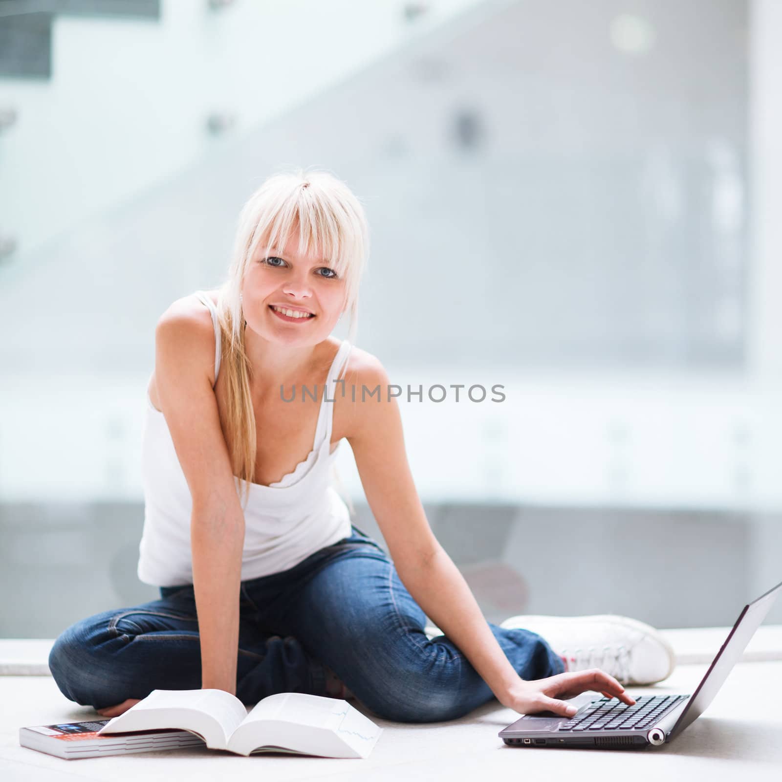 On campus - pretty female student with laptop and books working  by viktor_cap