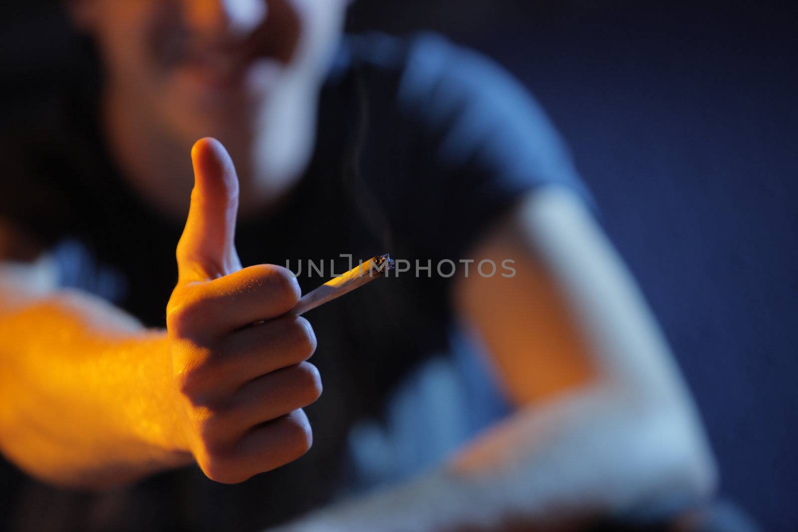 Young man shows thumbs up